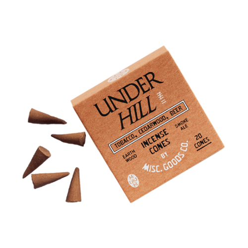 Box of Under Hill incense cones with cones spilling out on a white background