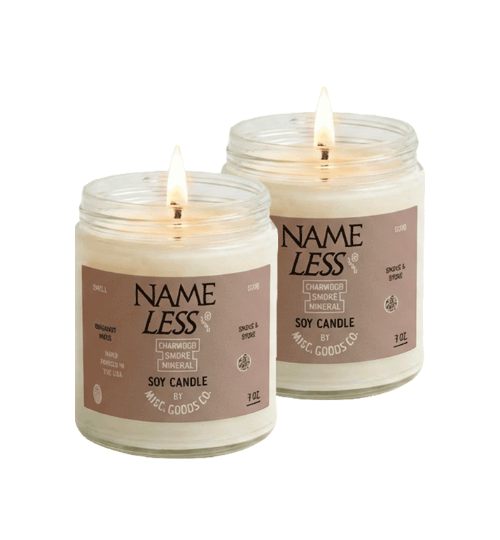 Two Name Less soy candles in glass jars with visible flames.