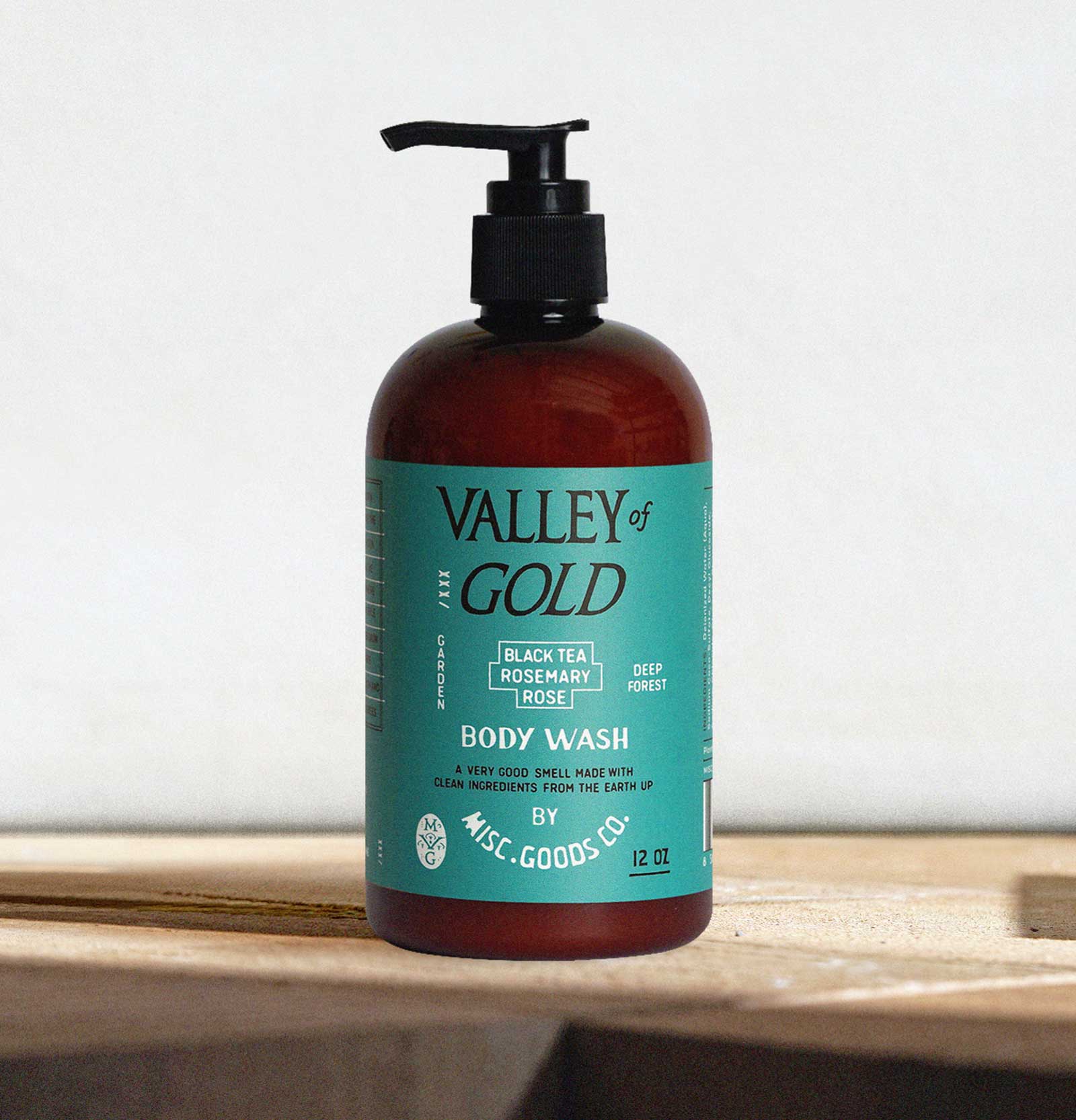 Valley of Gold body wash bottle with pump on a wooden surface