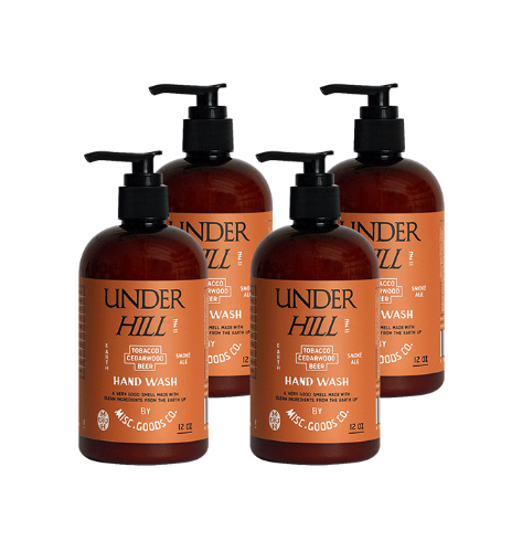 Four bottles of Under Hill hand wash with pump dispensers on a white background