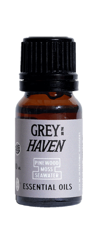 Bottle of Grey Haven essential oils with a black cap and gray label.