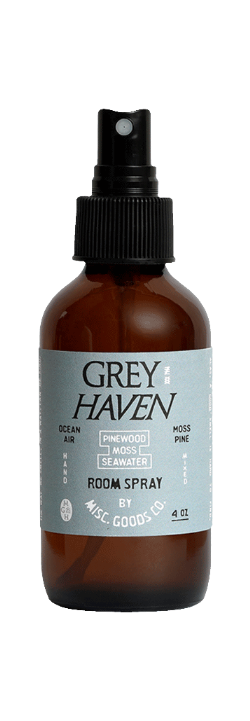 Brown bottle of Grey Haven room spray with a black sprayer on a white background