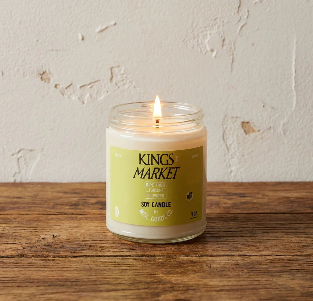 Kings Market candle on a wooden surface with a light background