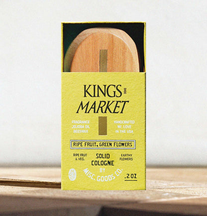 Kings Market solid cologne packaging with wooden applicator on a white background
