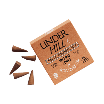 Box of Under Hill incense cones with cones spilling out on a white background