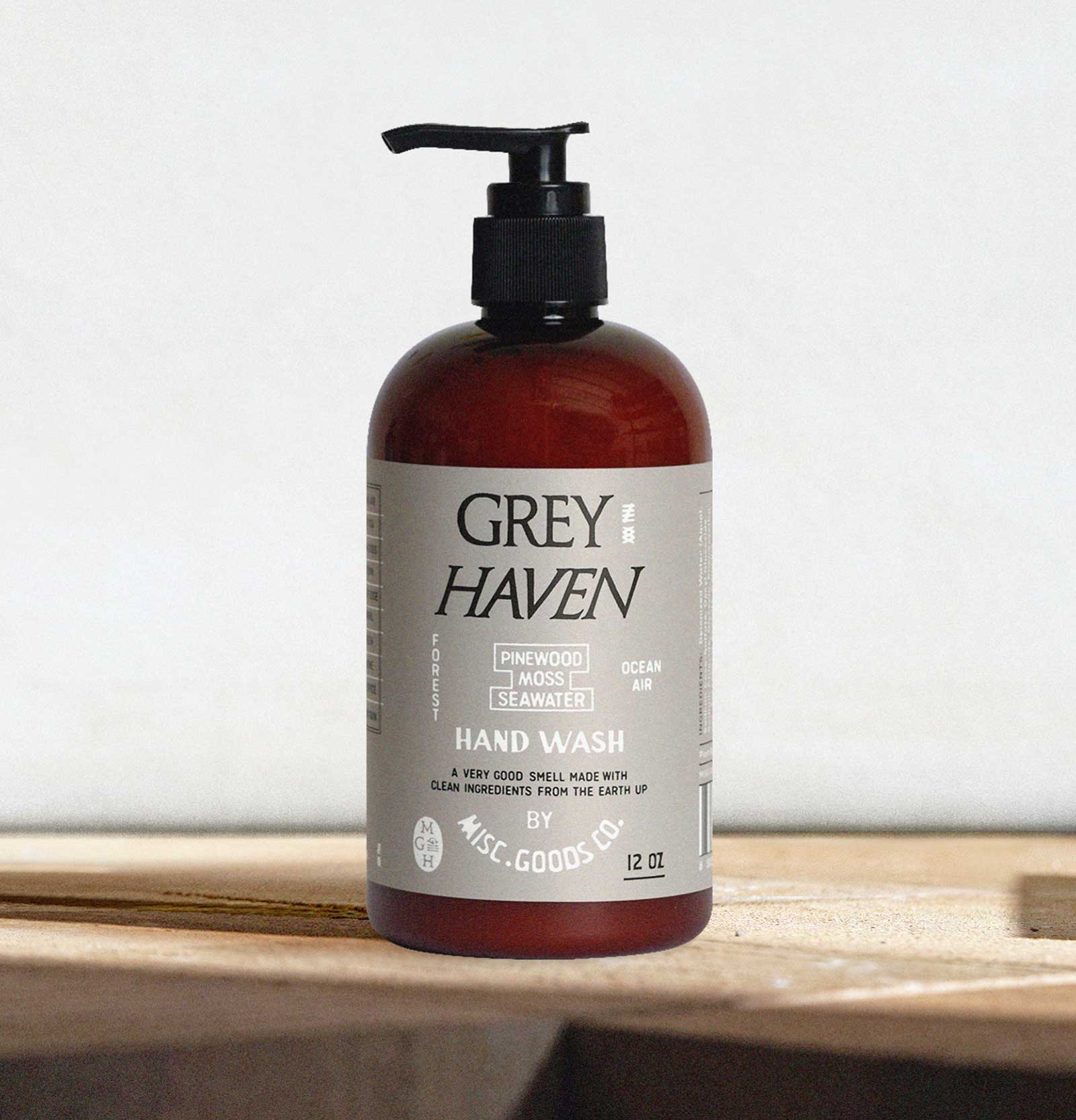 Bottle of Grey Haven hand wash on a wooden surface with a white background