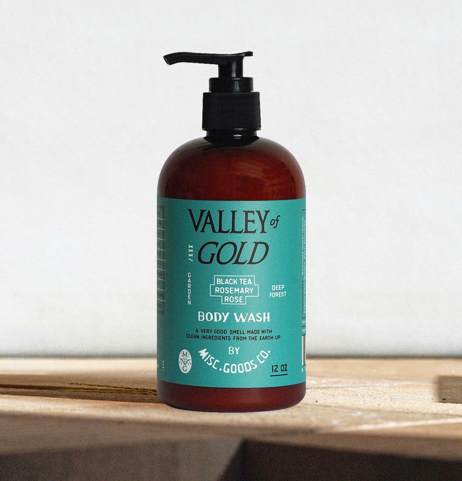 Valley of Gold body wash bottle with pump on a wooden surface